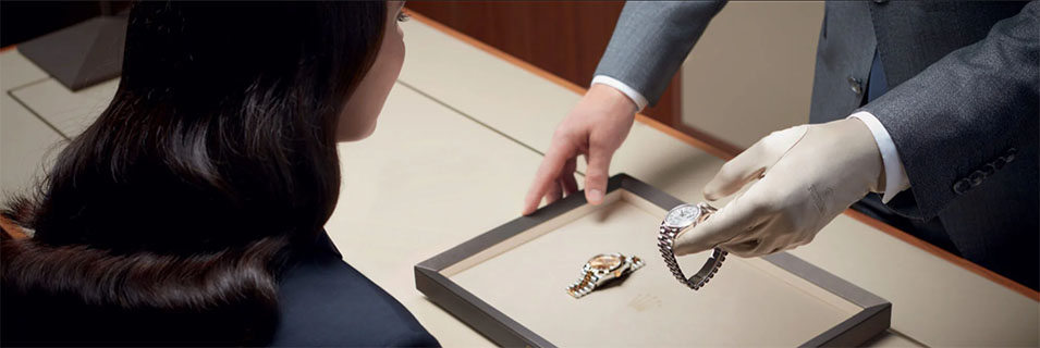 working on a desk with a rolex